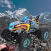 An orange and blue All-Terrain RC Monster Truck is shown in a rugged, rocky outdoor environment.