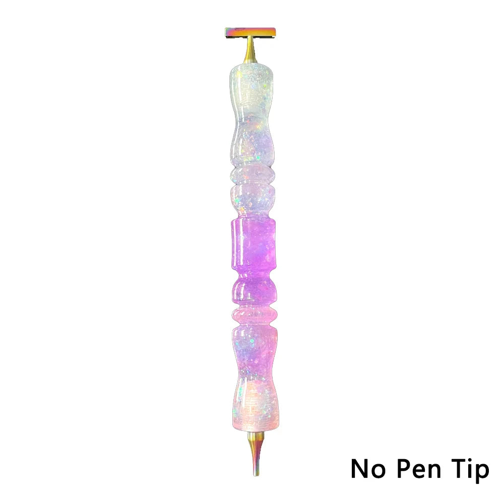 A long, clear glass pen with an interchangeable resin tip, featuring iridescent purple and pink colors.