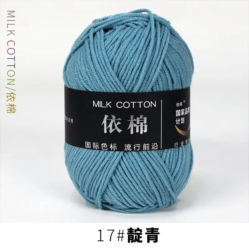 A skein of teal milk cotton yarn labeled 17# knitting and crochet thread.