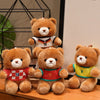 Three adorable teddy bears wearing football jerseys numbered 10, 7, and 9 sitting on a wooden surface.