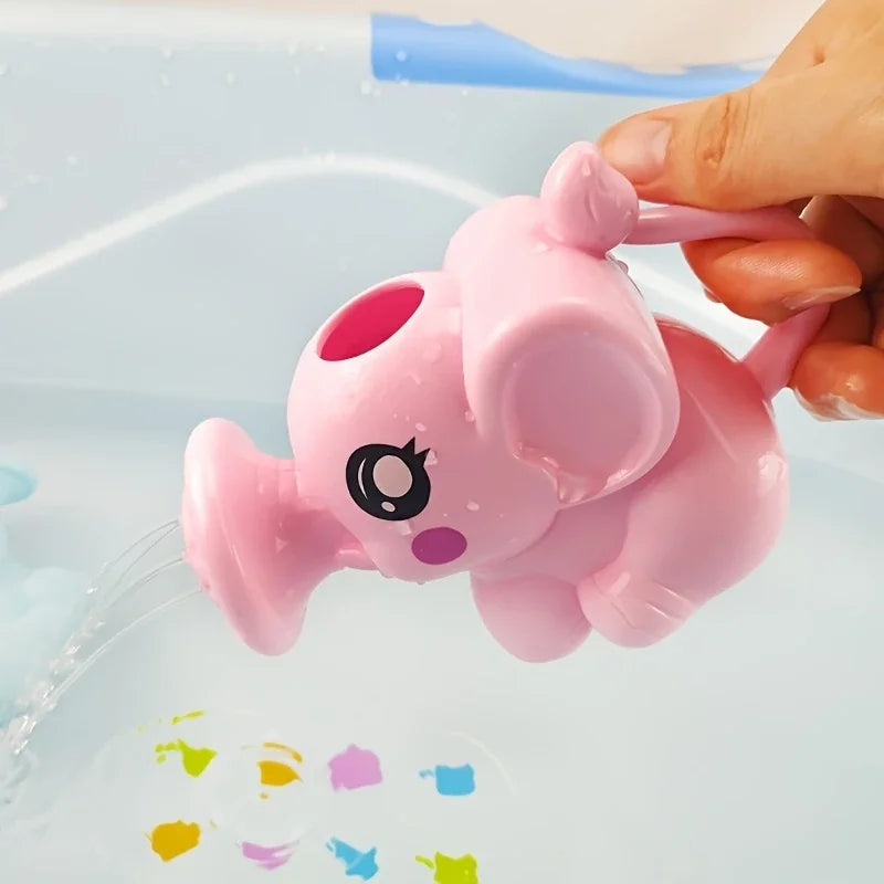 A hand is holding a pink elephant bath toy, which is being used to dispense water into a blue plastic tub.