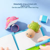A pink turtle-shaped water gun is shown next to a ruler and a notebook, illustrating its use as a learning tool.