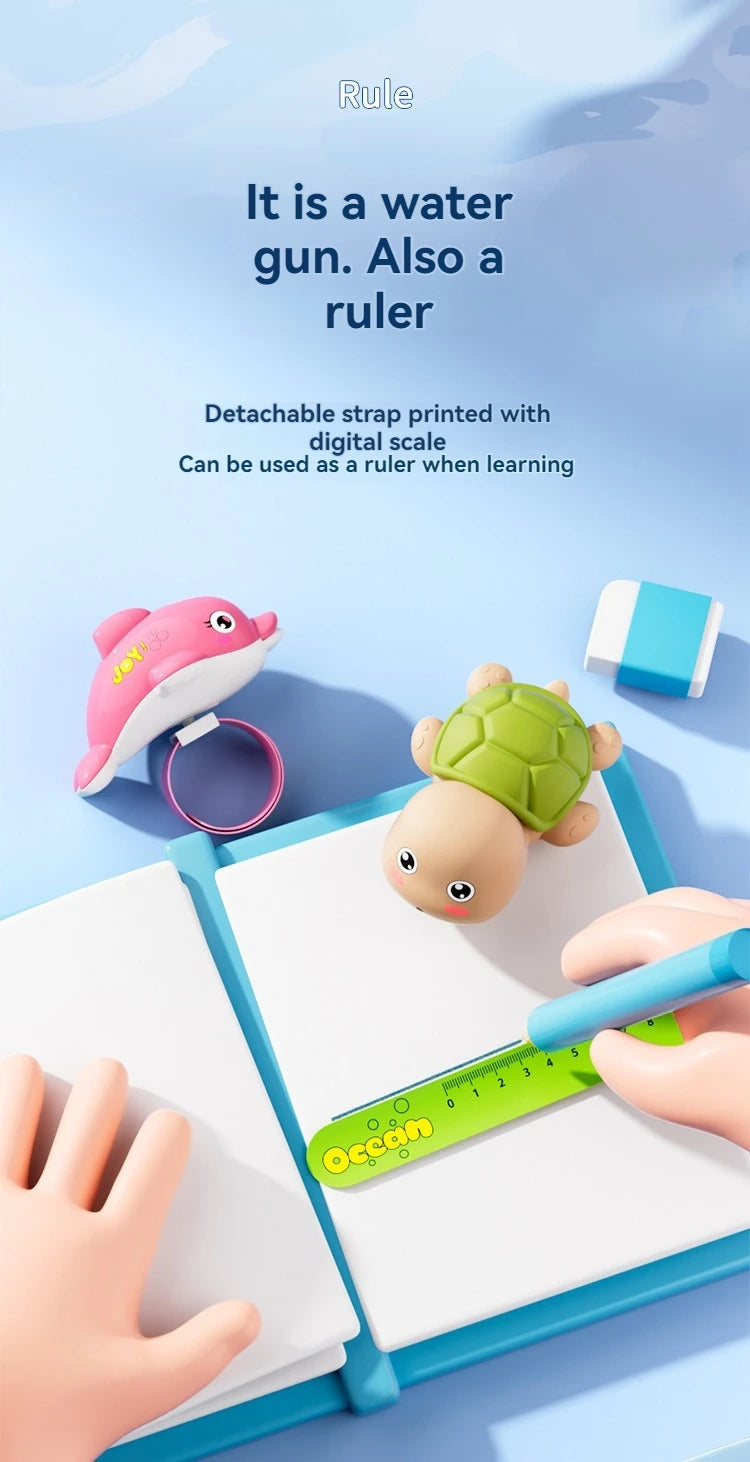 A pink turtle-shaped water gun is shown next to a ruler and a notebook, illustrating its use as a learning tool.