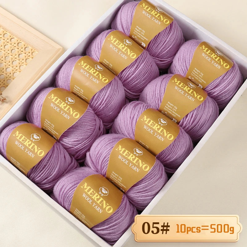 Box of purple Merino wool yarn balls with yellow labels, packaged for knitting projects.