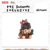 A collectible figure of a character with dark hair and a brown outfit, featuring a small green creature.