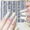 A hand displays silicone nail molds featuring various bowknot designs and a carving pen on a clear background.