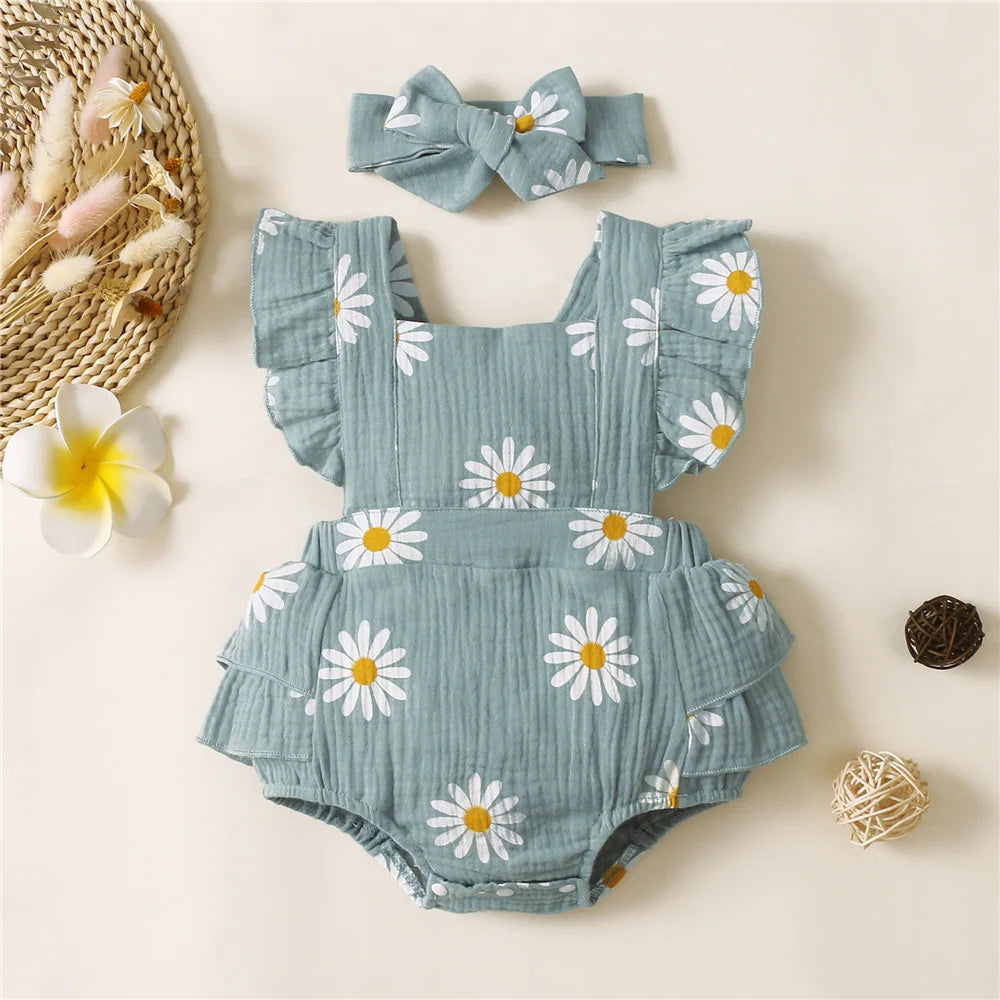 A light blue floral ruffle bodysuit for a baby girl is displayed on a neutral background.