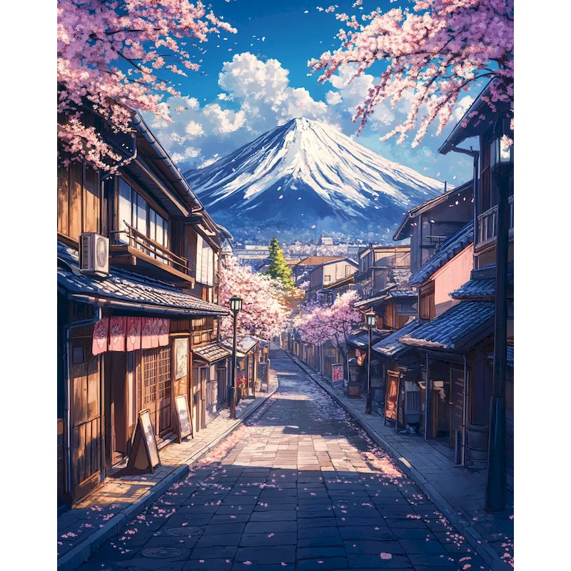 A scenic view of a Japanese town with pink cherry blossoms leading toward Mount Fuji.