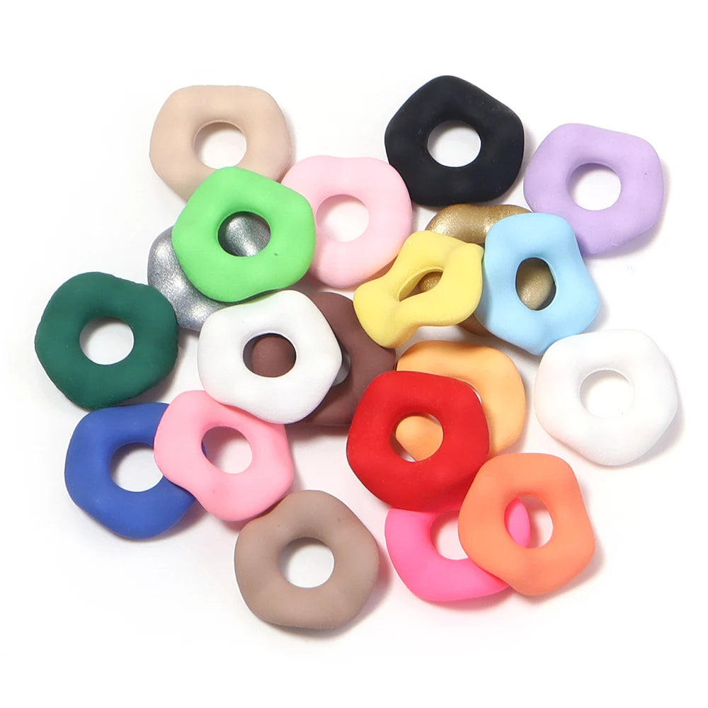 Assortment of candy colored acrylic spacer beads in various pastel and dark shades