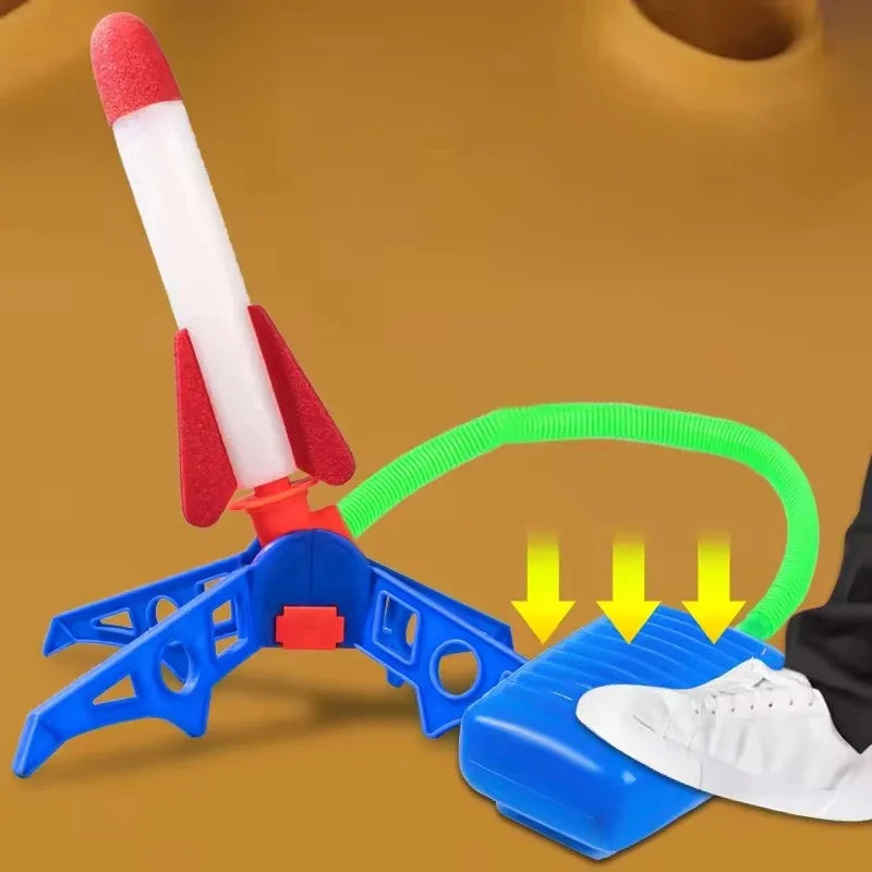 A red and white air-powered stomp rocket launcher with a green handle and blue base for outdoor play.