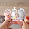 A pair of adorable bear soft sole first walker shoes for babies in pink and white are being held by a person.