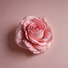 A soft pink rose made of floral silicone mold used for crafting candles, soap, and clay.