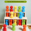 A set of colorful, round wooden figures in various shades of orange, red, yellow, green, and blue arranged on a white table.