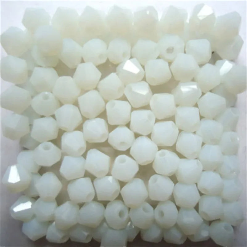A collection of white faceted glass bicone beads for jewelry making