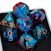 A collection of handmade resin sharp edge dice in various colors and shapes displayed on a dark surface.