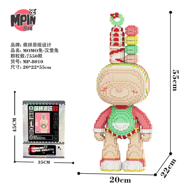 A fully assembled bear figure made of pink and yellow micro building blocks with stacked green and red accessories.