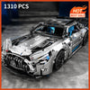 A detailed 1:14 scale sports car model kit featuring a silver and black racing car with custom bodywork.