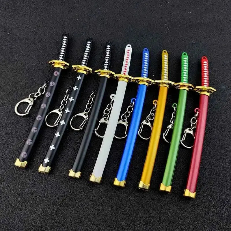 A collection of nine samurai swords in various colors, including black, white, blue, yellow, and green, displayed as keychain