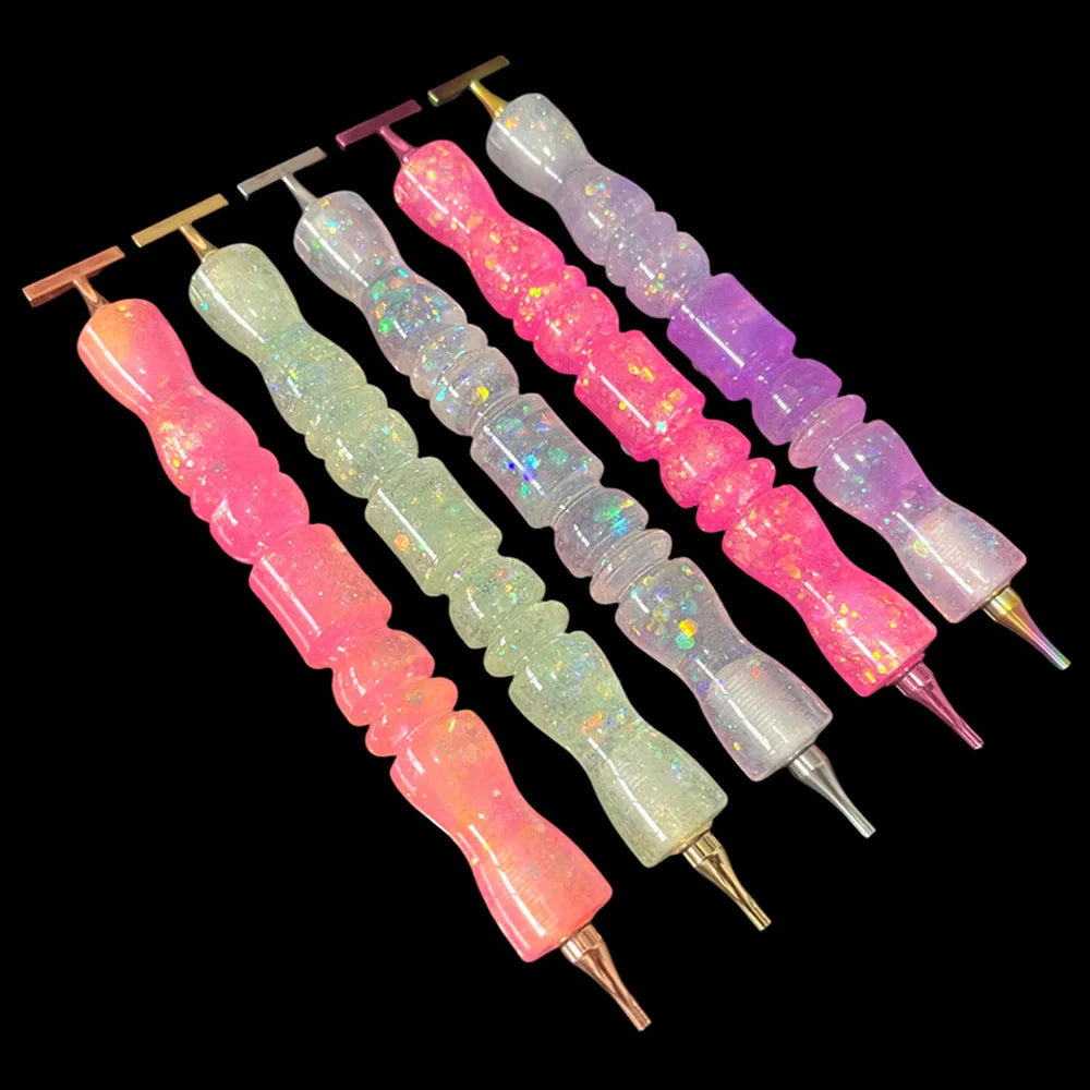A set of glitter resin diamond painting pens with colorful, wavy handles arranged diagonally against a black background.