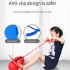 A young girl is using a red bouncing ball trainer for balance and coordination exercise.