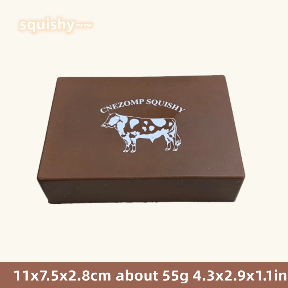 Jouet en forme de vache marron et moelleux avec l'inscription CNEZOM SQUISHY.