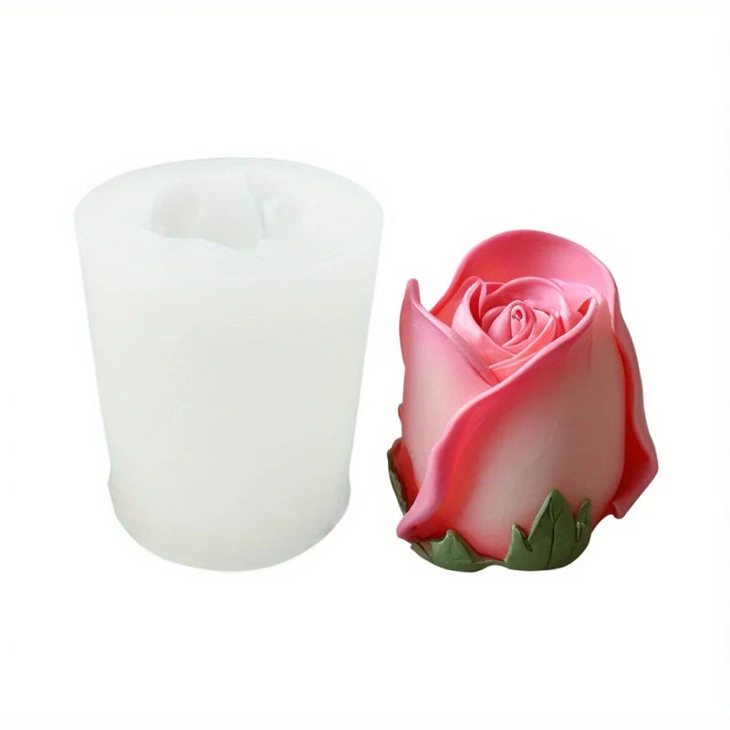 A pink rose silicone candle mold with green leaves shown next to a white candle.