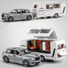 A silver diecast metal RV camper truck model with a white camper unit and a separate car model.