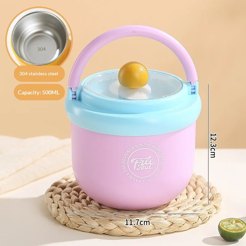A pink insulated stainless steel breakfast cup with a light blue lid and a yellow ball, resting on a woven mat.