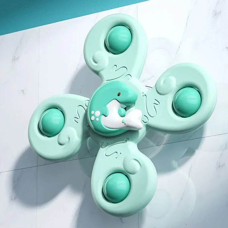 A set of light mint green suction cup spinner bath toys for toddlers, featuring multiple round silicone spinners.