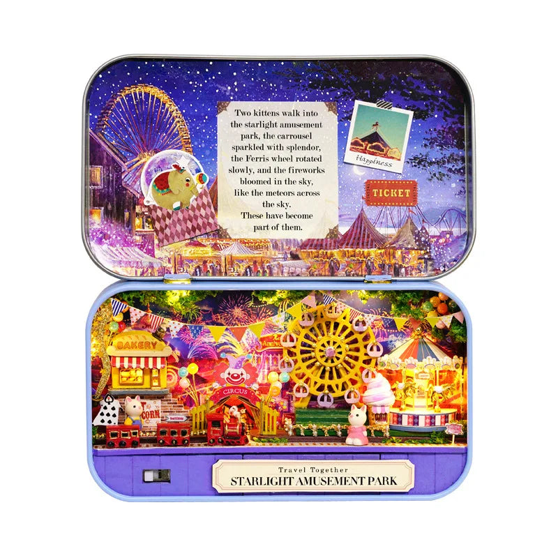 A purple wooden box containing a Starlight Amusement Park themed kit with miniature figures and scenery.