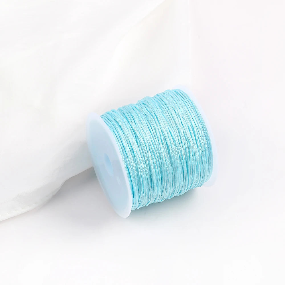 A roll of light blue cotton nylon macrame cord for jewelry making and crafts.