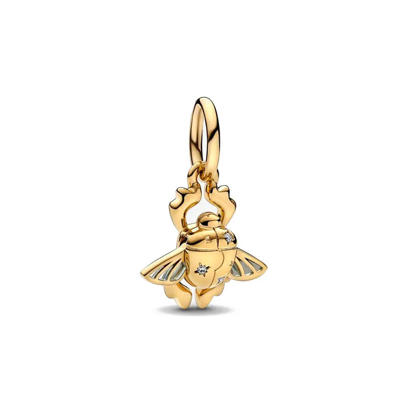 A gold-toned charm bracelet featuring pendants shaped like an elephant, key, butterfly, and heart.