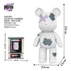 A white bear micro building block kit with purple and gray paint splatters.
