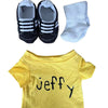 A yellow t-shirt with the name Jeffy printed on it, next to a pair of black and white socks and a hand puppet.