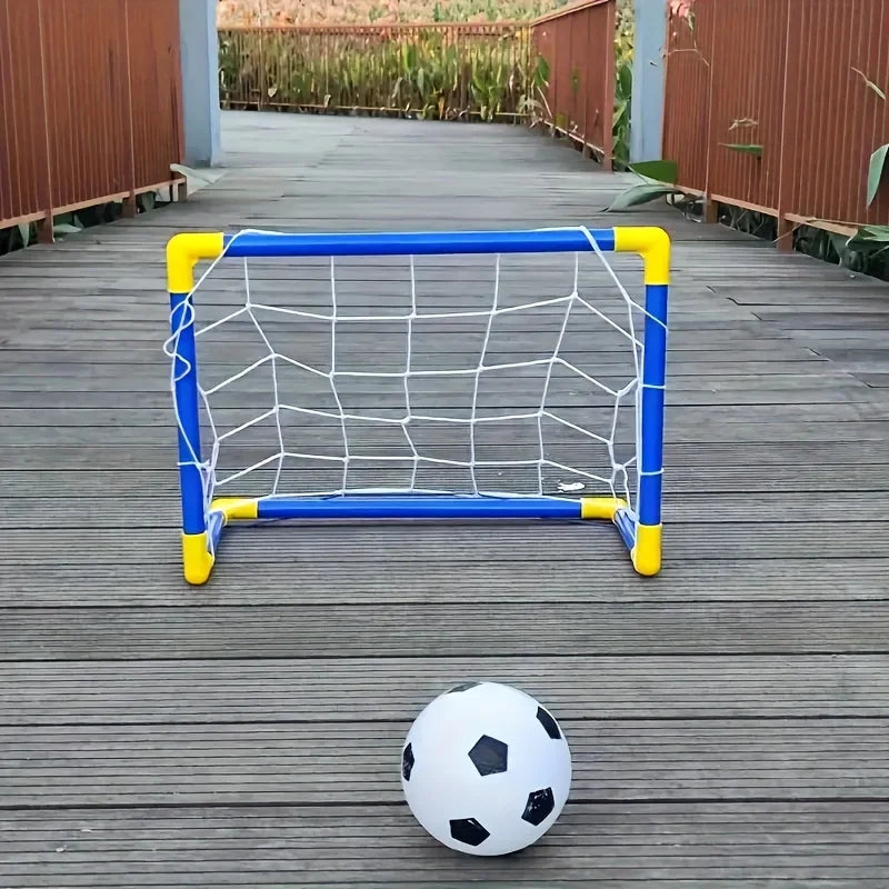 A portable soccer goal frame with a net and a ball are placed on a wooden deck.