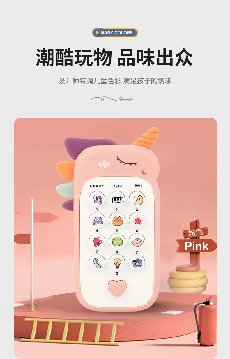 A pink baby phone toy with various buttons and a heart shape is displayed on a wooden surface.