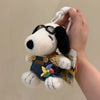 A white dog plush toy with black ears and sunglasses is being held, attached to a keychain.
