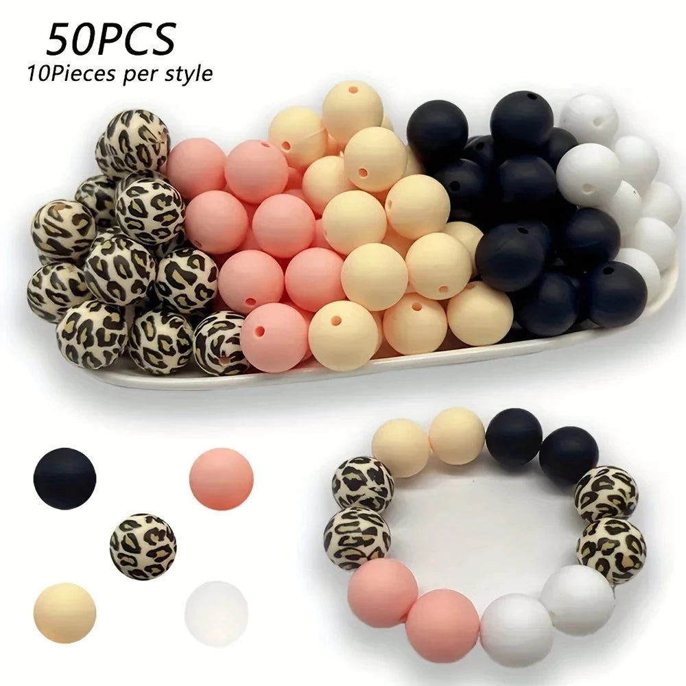 A collection of 50 silicone floral beads in various colors including black, white, pink, and beige, arranged for DIY jewelry 