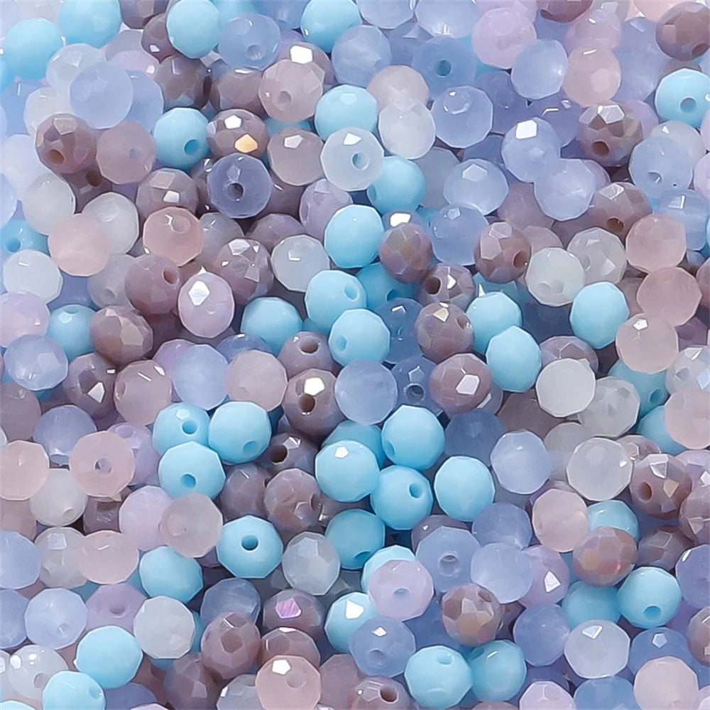 Mixed color faceted rondelle glass beads in shades of blue, pink, and gray for jewelry making