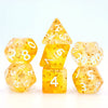 A set of yellow translucent polyhedral dice, including a pyramid and a dodecahedron, displayed on a white background.