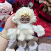 A white Skullpanda You Found Me! Series collectible figure is held against a background of other figures and packaging.
