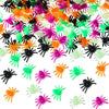 A pile of realistic fake spiders in various bright colors including orange, pink, green, and black.