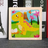A wooden tangram puzzle featuring a yellow dinosaur and pink flowers on a green background.