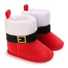 A pair of red baby first walker shoes with white faux fur trim and black accents.