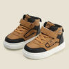 A pair of tan and black kids' high-top sneakers with easy velcro straps shown from the side.