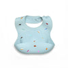 Light blue silicone baby bib with various colorful shapes and a strap for adjustable neck