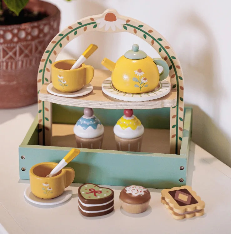 A wooden pretend play tea party set featuring a yellow teapot and cups displayed in a decorative arch stand.