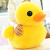 A person is holding a bright yellow plush toy shaped like a duck.