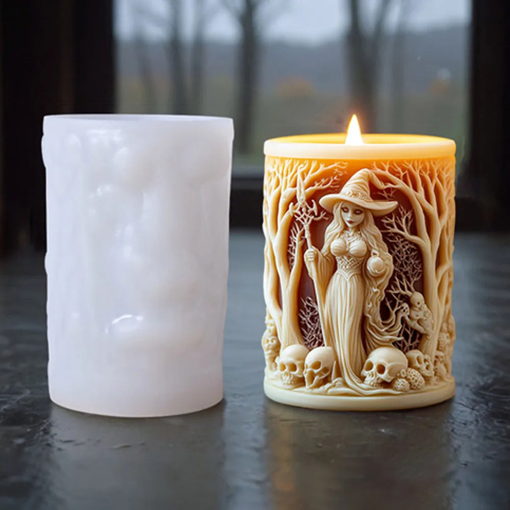 A lit silicone candle mold shaped like a witch portrait with a hat and flowing hair, set next to a white pillar candle.