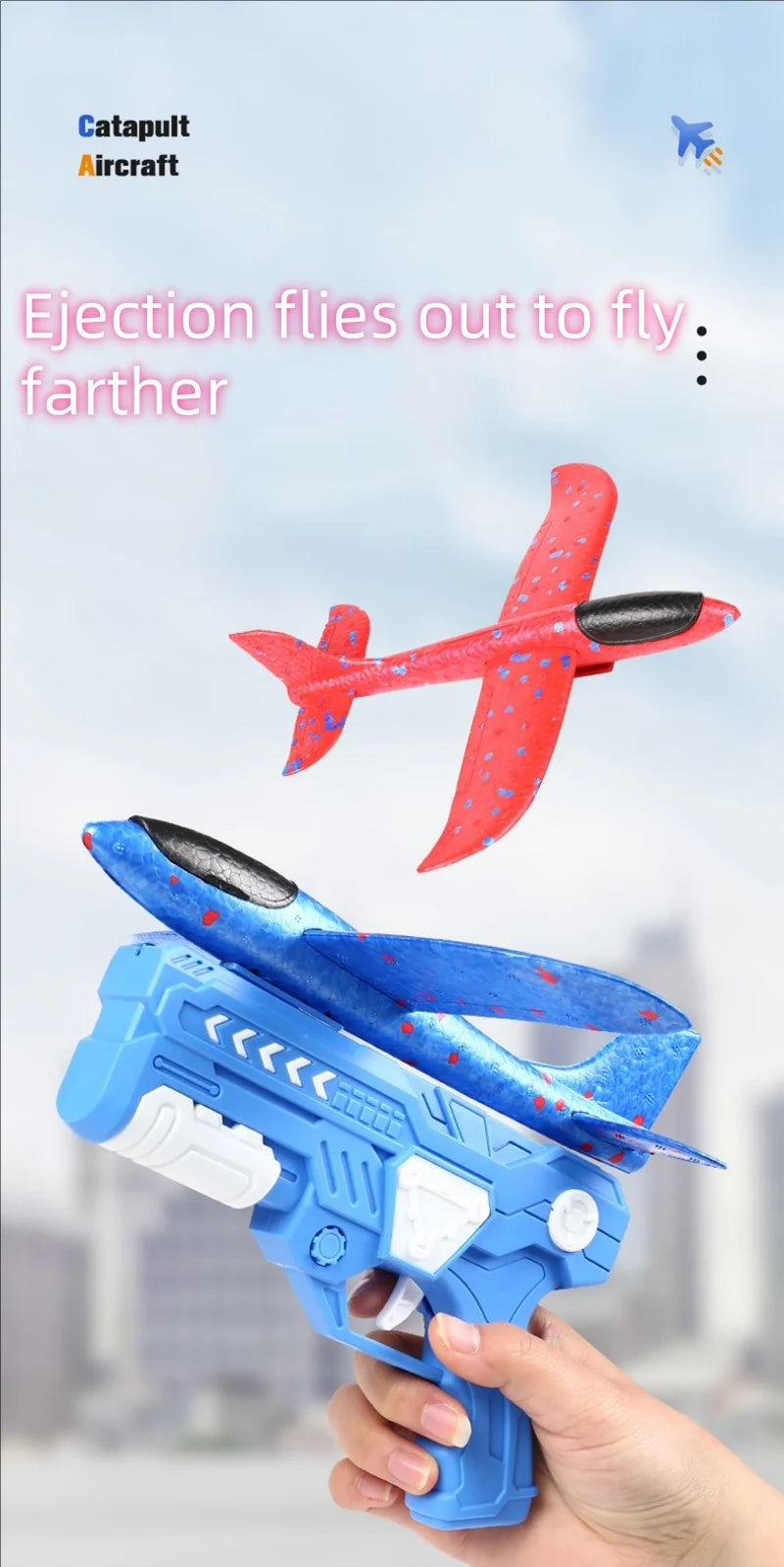 A hand holds a blue foam glider catapult toy gun with red accents against a light sky background.